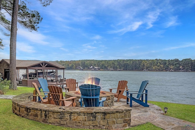 view of patio / terrace featuring a water view and an outdoor fire pit