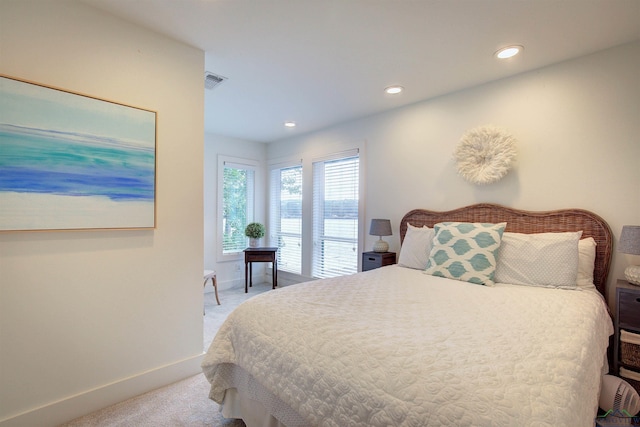 bedroom featuring light colored carpet