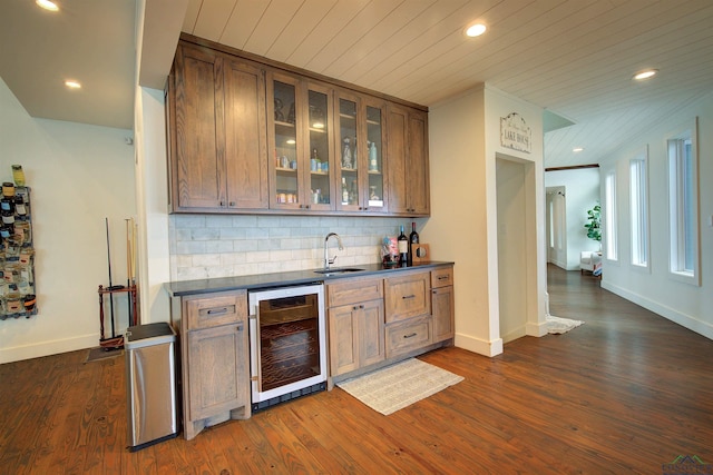 bar with sink, beverage cooler, dark hardwood / wood-style flooring, decorative backsplash, and wood ceiling