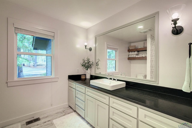 bathroom featuring vanity and toilet