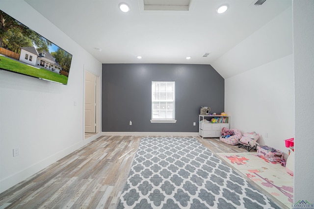 playroom with lofted ceiling and light hardwood / wood-style flooring