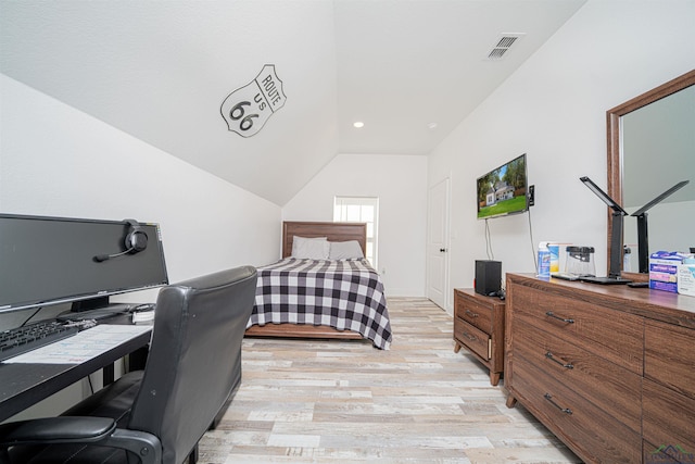 bedroom with lofted ceiling and light hardwood / wood-style flooring