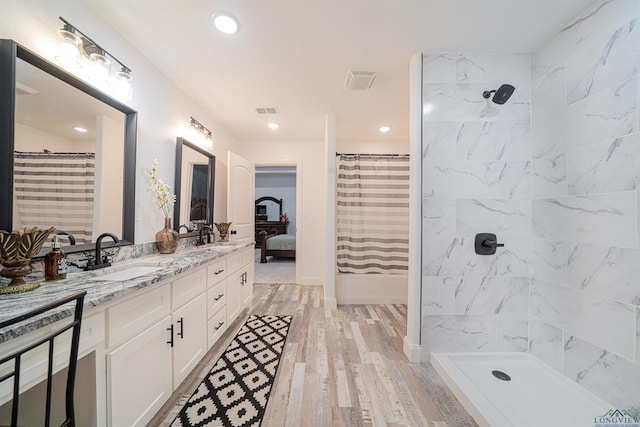 bathroom with a shower with curtain, vanity, and hardwood / wood-style flooring