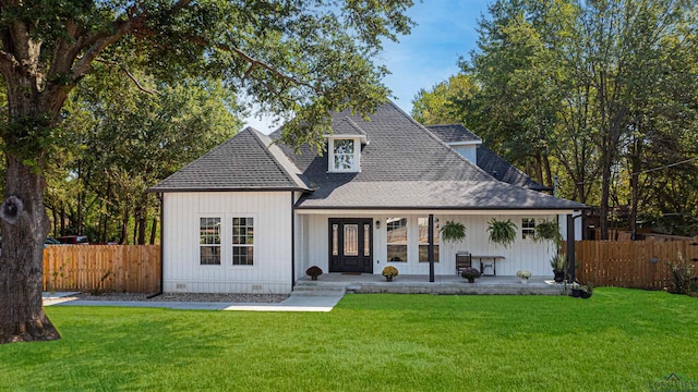 view of front facade with french doors and a front lawn