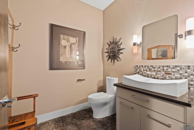 bathroom featuring decorative backsplash, vanity, and toilet