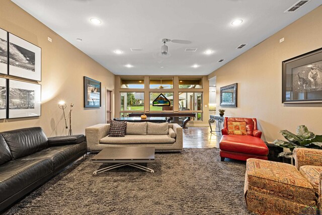 living room featuring ceiling fan and carpet