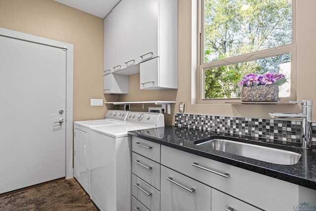 laundry room with cabinets, independent washer and dryer, and sink