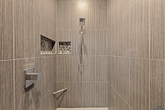 bathroom with a tile shower