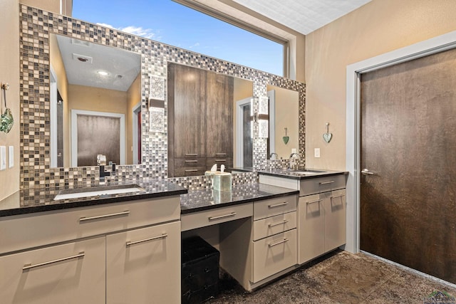 bathroom featuring tasteful backsplash and vanity