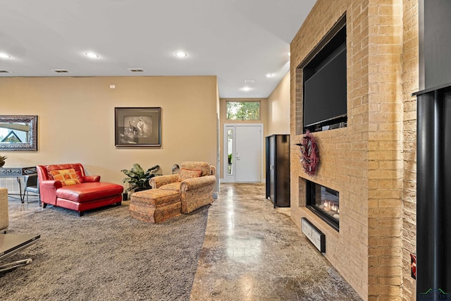 living room with a brick fireplace