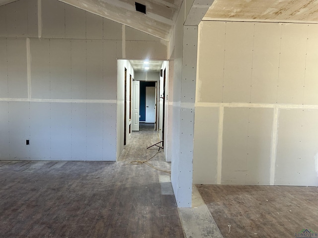 unfurnished room featuring vaulted ceiling