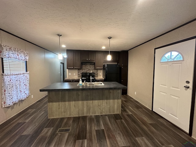 12700 2184 D, Tatum, TX 75691 - kitchen featuring black appliances, a sink, dark countertops, dark wood-style flooring, and tasteful backsplash