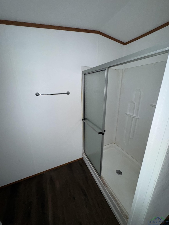 12700 2184 D, Tatum, TX 75691 - bathroom featuring wood finished floors, a stall shower, crown molding, and vaulted ceiling