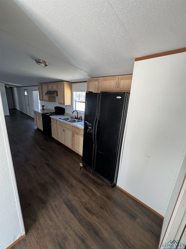 12700 2184 D, Tatum, TX 75691 - kitchen featuring black appliances, light brown cabinetry, a sink, dark wood-style flooring, and a textured ceiling