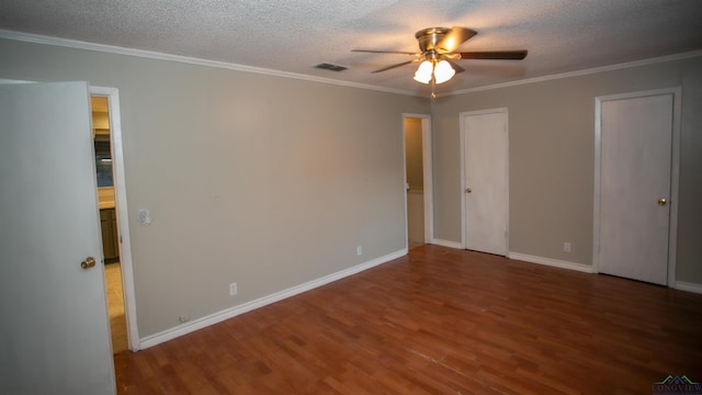 unfurnished bedroom featuring wood-type flooring, a textured ceiling, ceiling fan, and ornamental molding