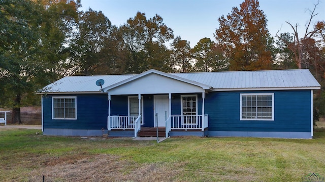 ranch-style home with a porch and a front yard