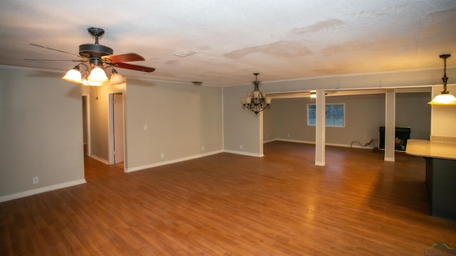 basement with ceiling fan, hardwood / wood-style floors, and a textured ceiling