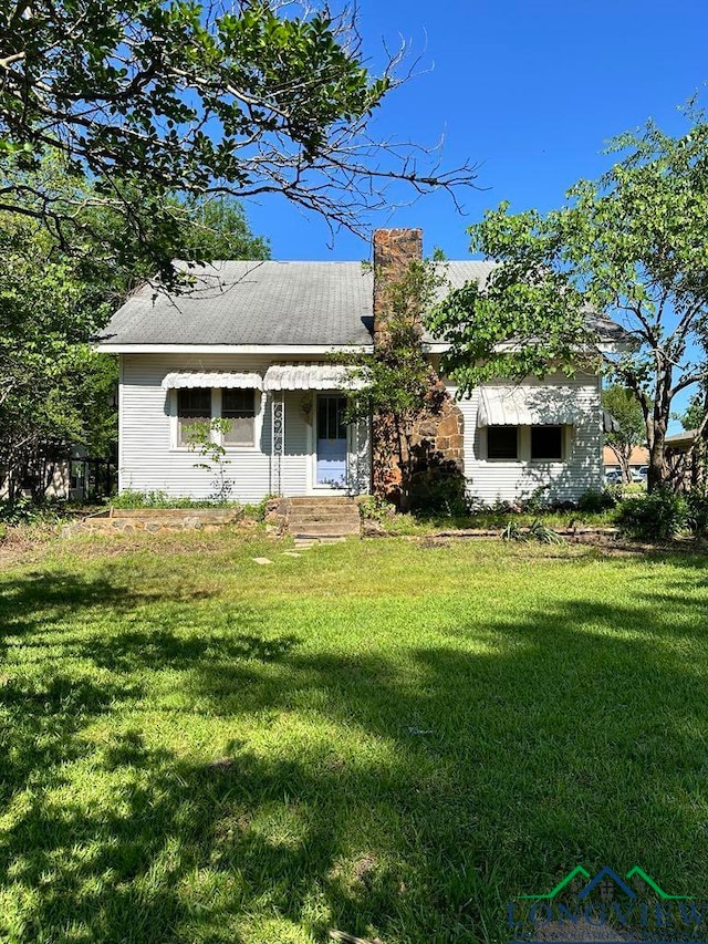 ranch-style home with a front lawn