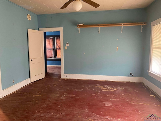 empty room with ceiling fan and dark hardwood / wood-style floors