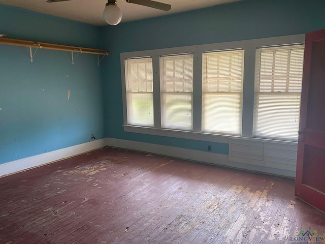 empty room with wood-type flooring and ceiling fan