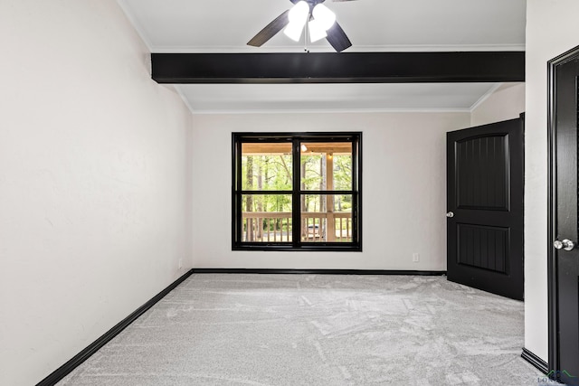 carpeted empty room featuring beam ceiling, ceiling fan, and crown molding