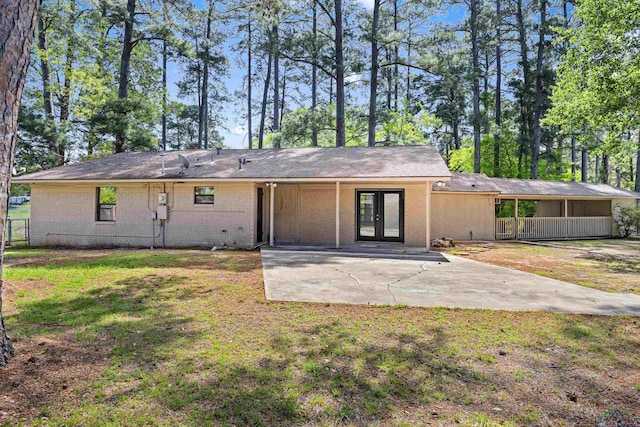 back of property featuring a lawn