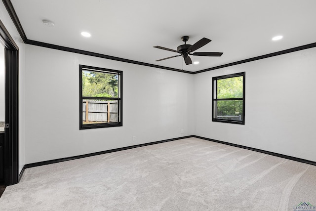 unfurnished room with a healthy amount of sunlight, ceiling fan, crown molding, and light colored carpet