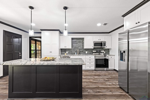 kitchen featuring light stone countertops, appliances with stainless steel finishes, dark hardwood / wood-style flooring, tasteful backsplash, and hanging light fixtures