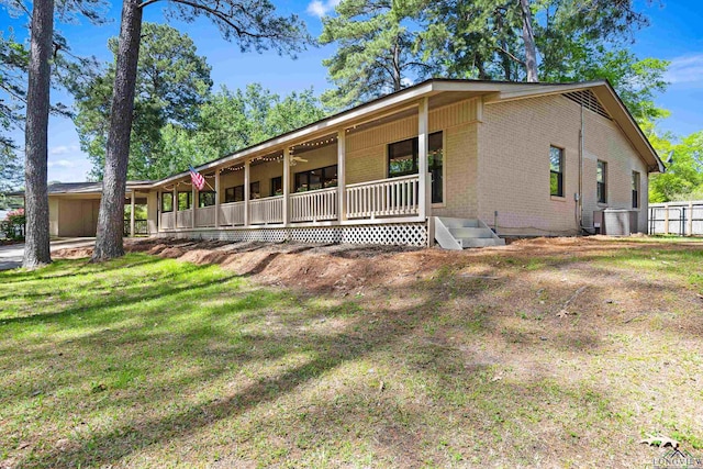 view of front of property with a front yard and cooling unit