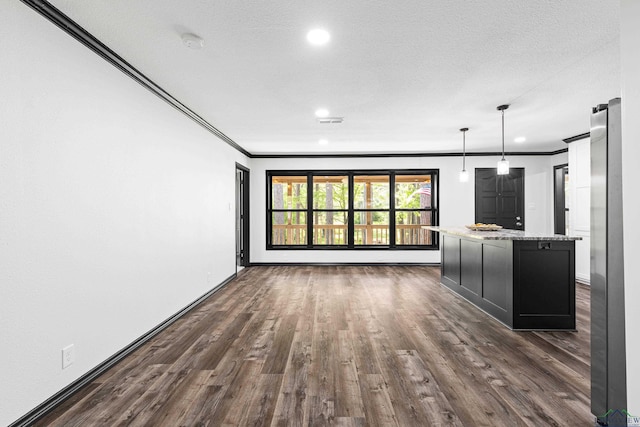 unfurnished living room with a textured ceiling, dark hardwood / wood-style floors, and crown molding