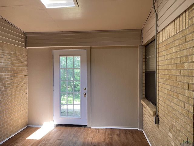 411 E Carolanne Blvd, Marshall, TX 75672 - entryway with brick wall, wood finished floors, plenty of natural light, and baseboards