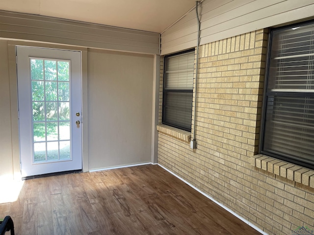 411 E Carolanne Blvd, Marshall, TX 75672 - entryway featuring healthy amount of natural light, vaulted ceiling, wood finished floors, baseboards, and wood walls