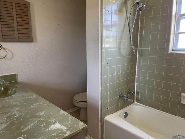 411 E Carolanne Blvd, Marshall, TX 75672 - full bathroom featuring toilet, washtub / shower combination, vanity, a textured wall, and baseboards