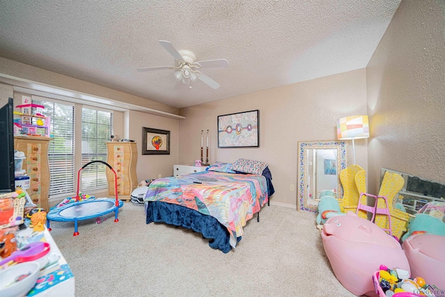 bedroom featuring carpet flooring, a textured ceiling, and ceiling fan