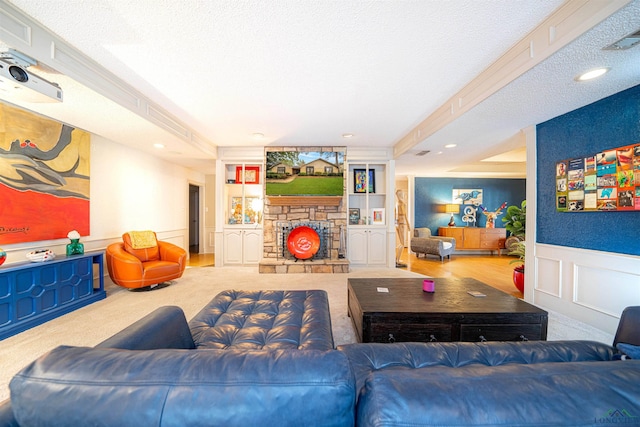 carpeted living room with a fireplace, built in features, and a textured ceiling