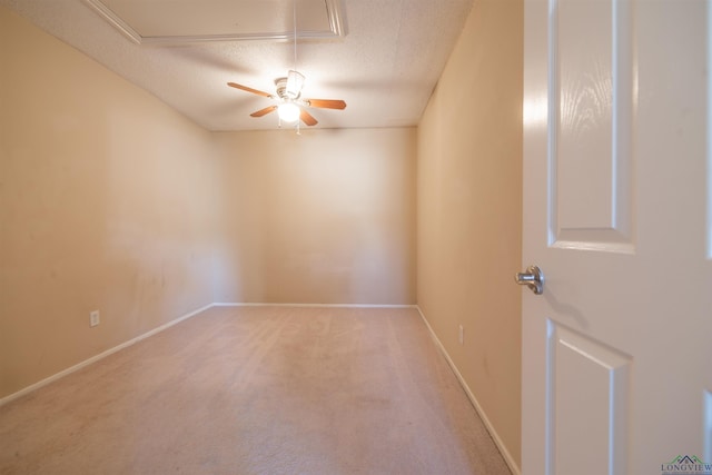 carpeted empty room featuring a textured ceiling and ceiling fan