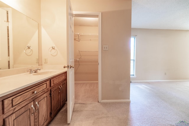 bathroom featuring a textured ceiling and vanity