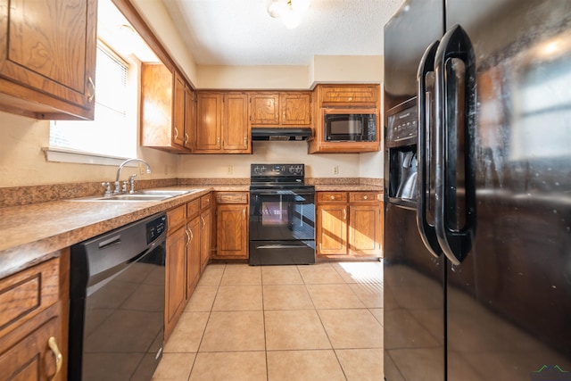 kitchen with sink, light tile patterned floors, a textured ceiling, and black appliances