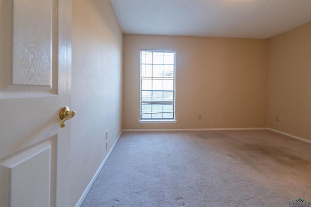 unfurnished room with light carpet