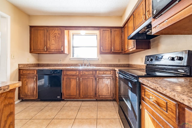 kitchen featuring sink, light tile patterned flooring, a textured ceiling, and black appliances