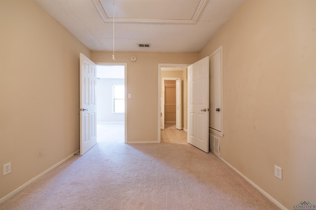 spare room featuring light carpet