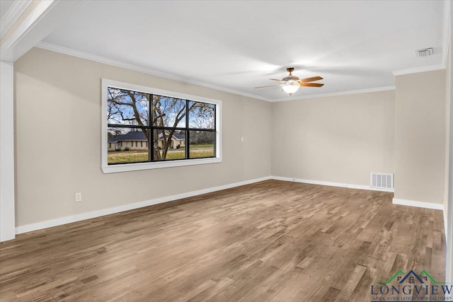 empty room featuring ceiling fan, crown molding, and hardwood / wood-style floors