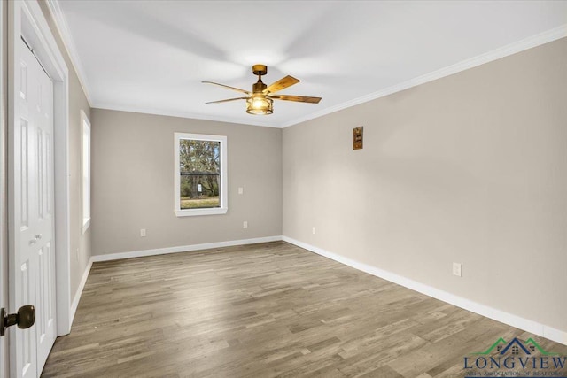 unfurnished room featuring ceiling fan, wood-type flooring, and crown molding