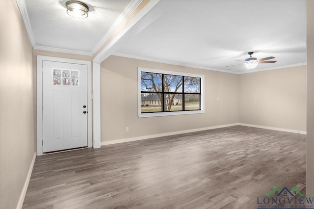 entryway with ceiling fan, hardwood / wood-style floors, ornamental molding, and a textured ceiling