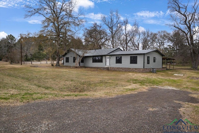 single story home with a front lawn and a carport