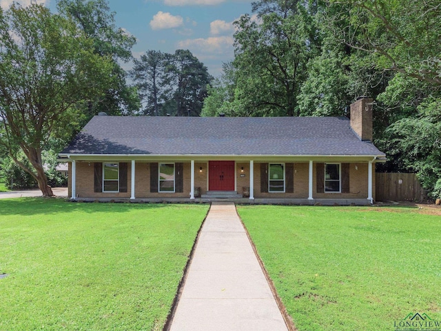 ranch-style home with covered porch and a front lawn