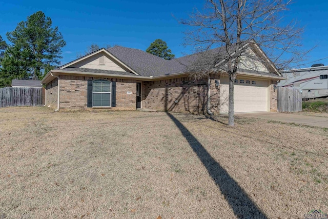 single story home featuring an attached garage, brick siding, fence, concrete driveway, and a front yard