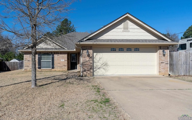 ranch-style home with a garage, brick siding, driveway, and fence