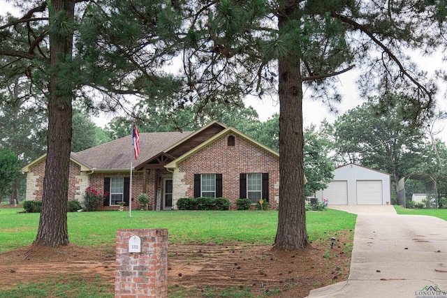 3713 Bell Mdws, Longview, TX 75605 - ranch-style home featuring brick siding, a front yard, an outdoor structure, and a detached garage