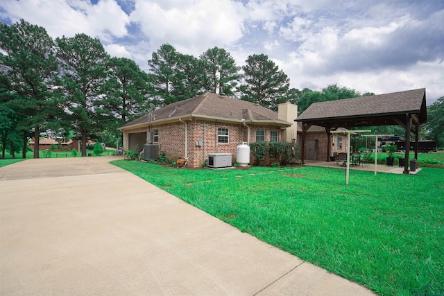 3713 Bell Mdws, Longview, TX 75605 - view of property exterior featuring a gazebo, a garage, brick siding, a lawn, and driveway